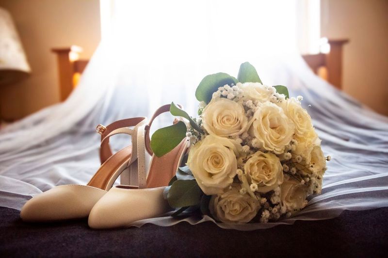 3 female figures stand looking forwards, shielding their eyes from the sun